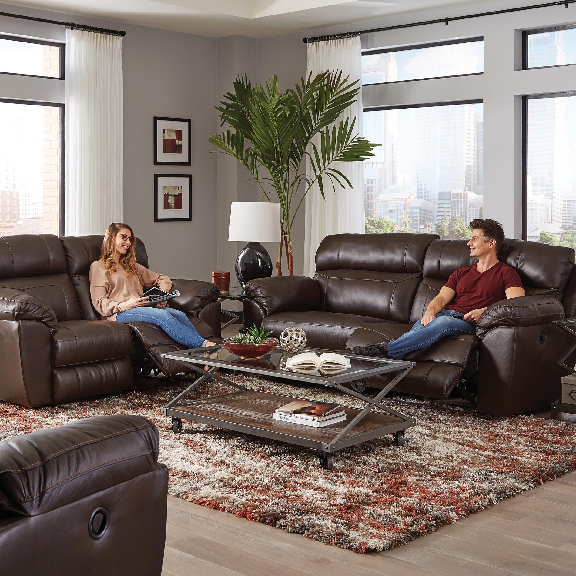 Living room with brown leather recliner sofas, a coffee table, and decorative elements.