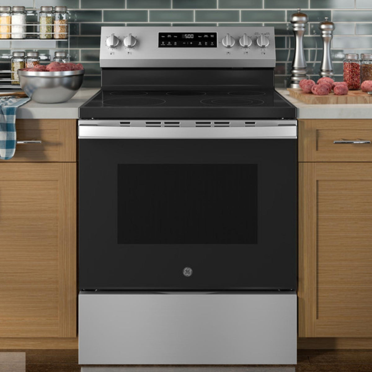 Stainless steel electric range with black cooktop in a kitchen setting