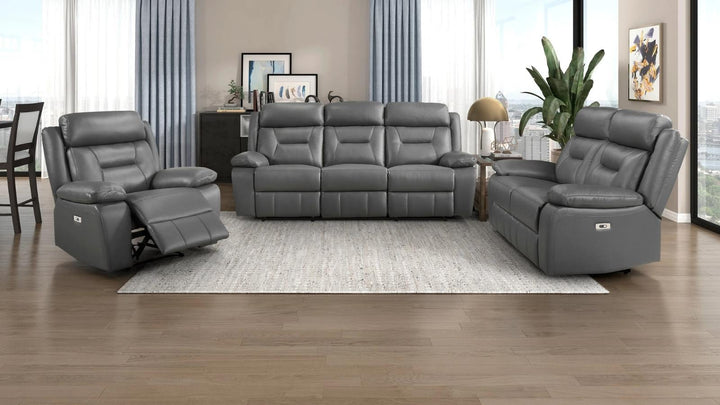 A 3-piece gray reclining living room furniture set consisting of a three-seat sofa, a two-seat recliner, and a matching single-seat recliner, arranged on a light gray rug in a modern living room.