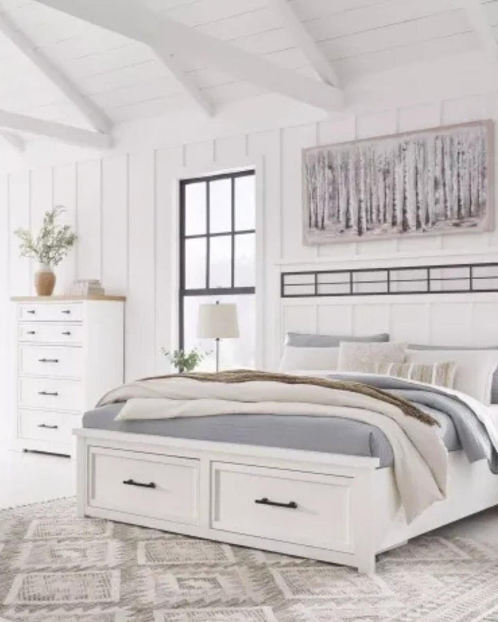 Neatly arranged bedroom with a white bed, dresser, and decorative elements.