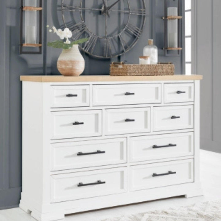 White dresser with wooden top in a room with decorative items.