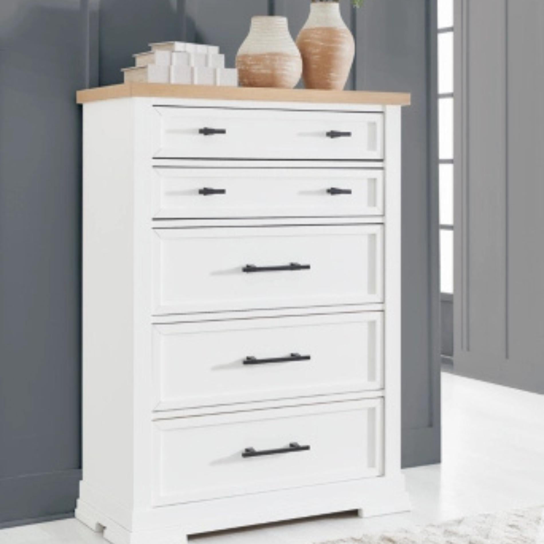 White dresser with wooden top against a gray wall