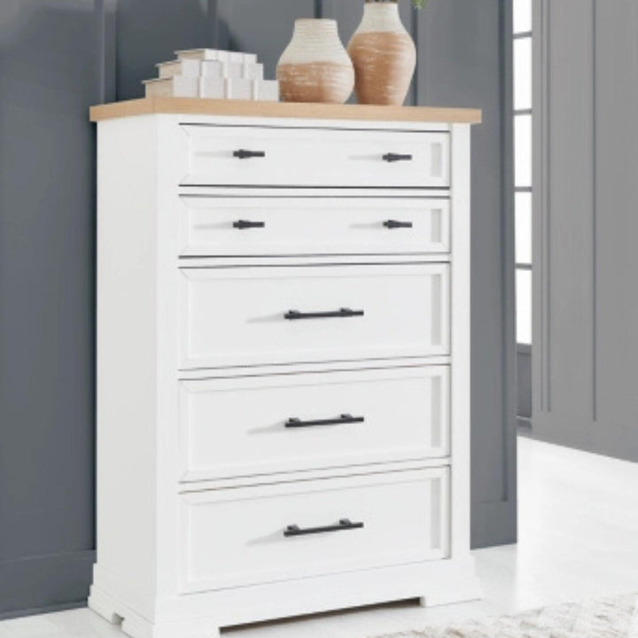 White dresser with wooden top against a gray wall