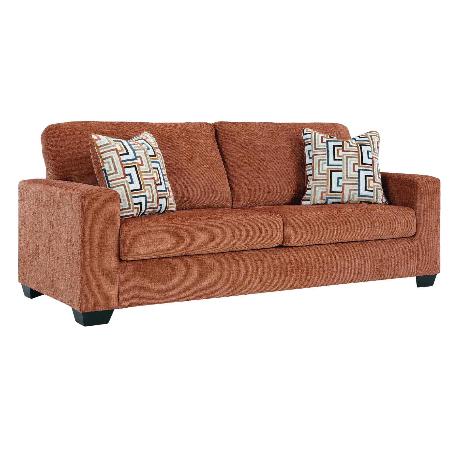 An orange-brown upholstered loveseat with two patterned accent pillows, shown on a plain white background.