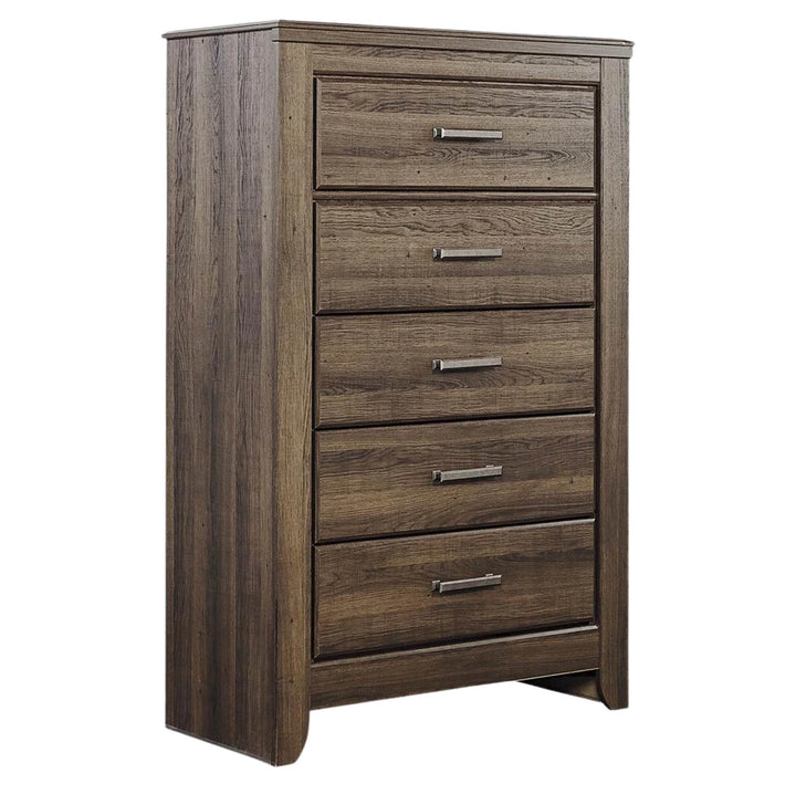 A five-drawer wooden chest of drawers with a medium brown wood grain finish and silver metal drawer pulls, shown on a plain white background.