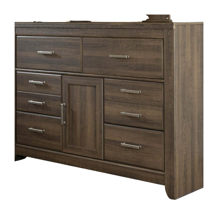 A dark brown wood dresser with a grain finish, featuring six drawers and one central cabinet door with silver metal handles, shown on a plain white background.