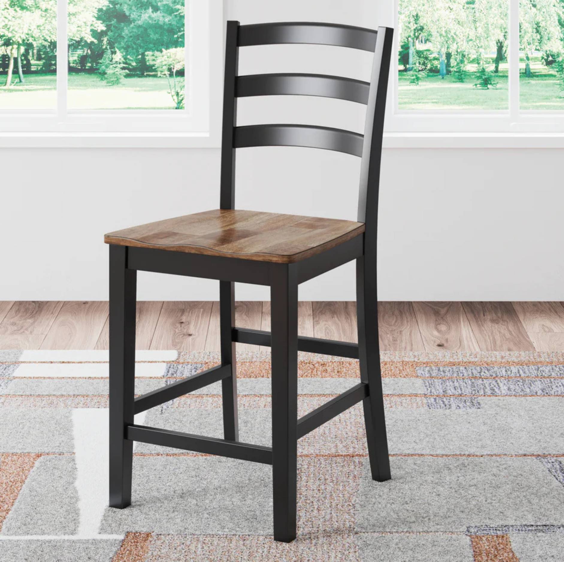 A counter-height stool with a black metal frame and ladder-back style backrest, featuring a warm brown wooden seat, shown on a patterned rug in front of a window.