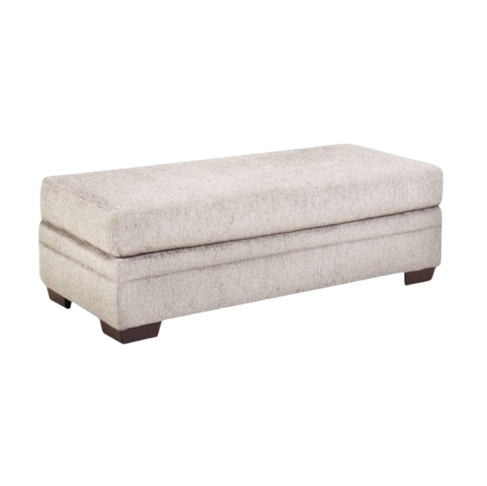 A rectangular upholstered ottoman bench with a textured light beige fabric and dark brown block feet, shown on a plain white background.