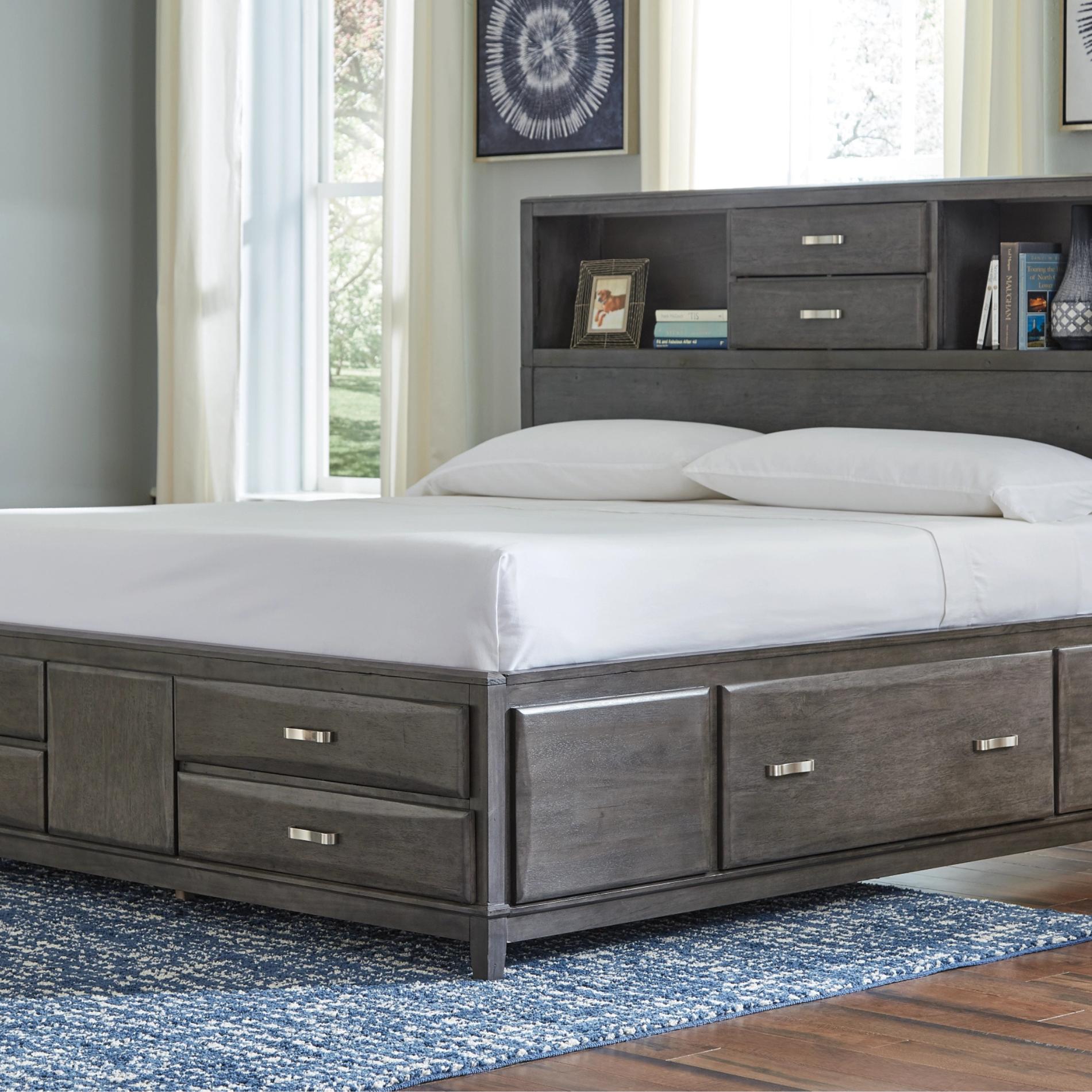 Gray wooden bed with storage drawers in a bedroom setting