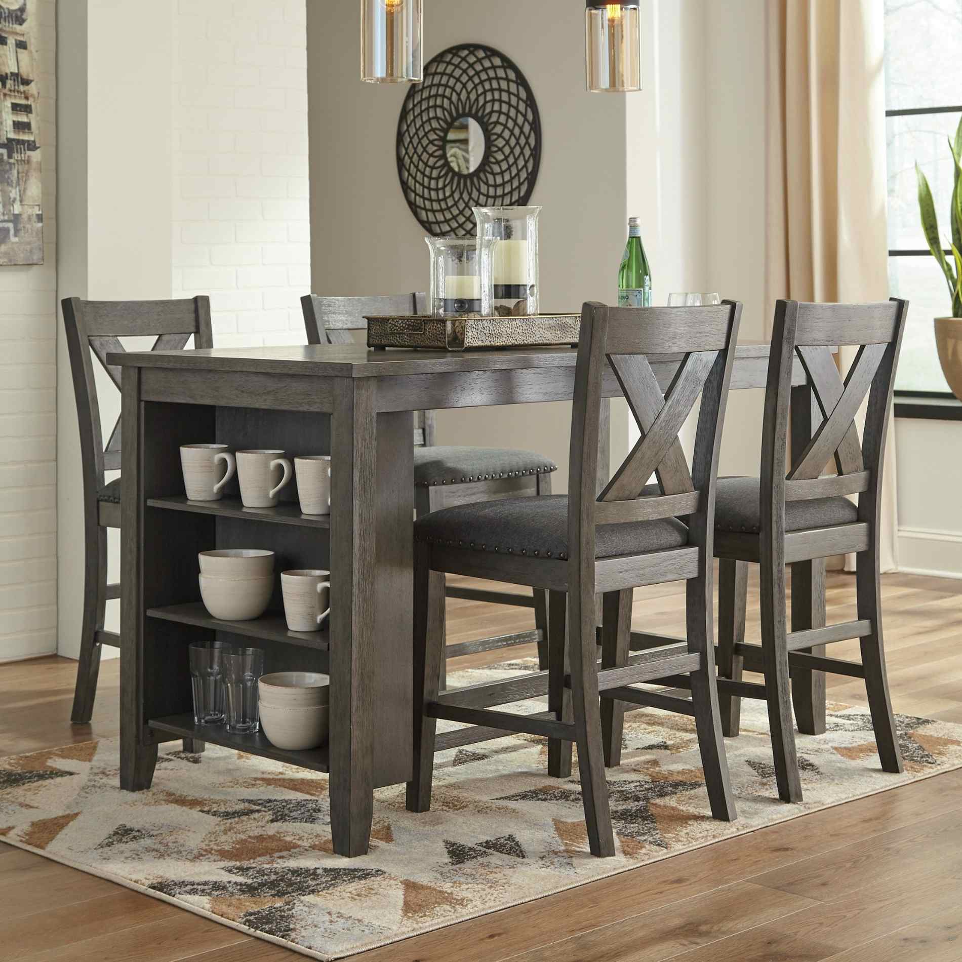 Dining room with a wooden table and chairs on a patterned rug.