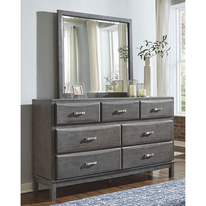 Gray dresser with mirror in a room with a window and plant