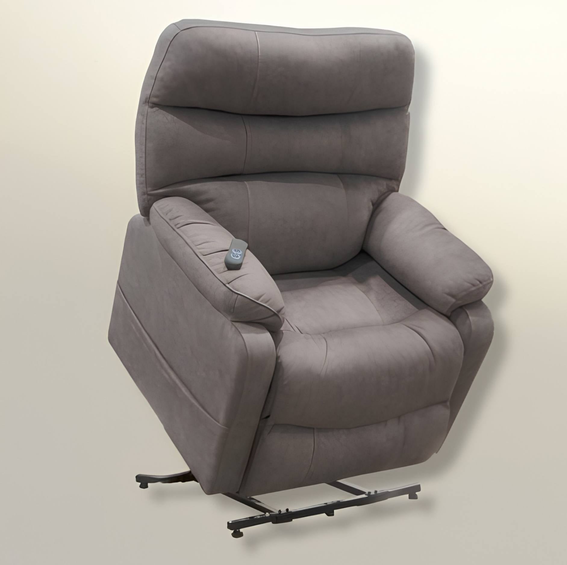 A gray upholstered recliner chair with a high back, padded armrests, and a small remote control on the armrest, shown on a light neutral background.