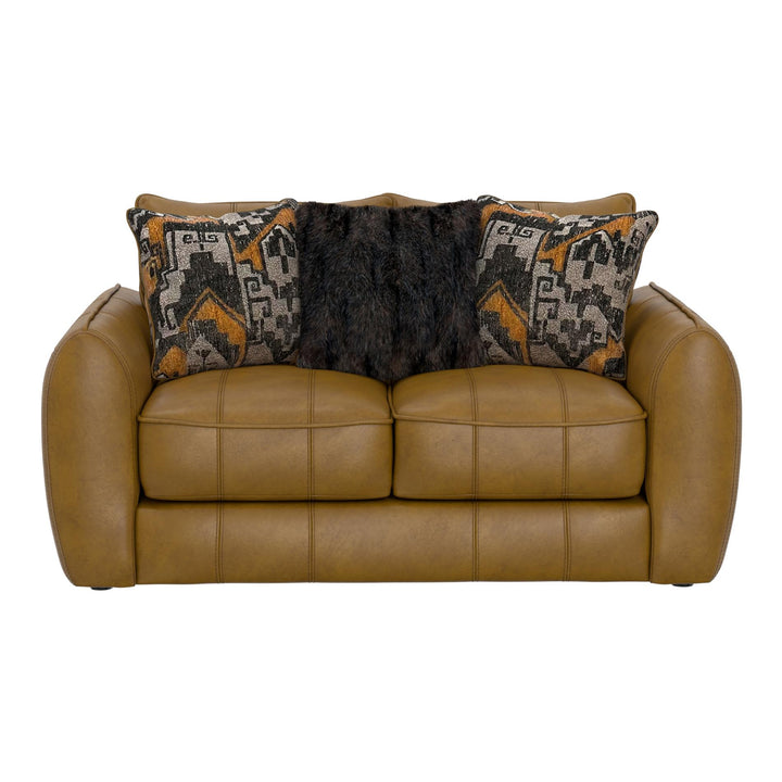 Brown leather sofa with patterned pillows on a white background