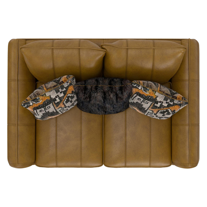 Brown leather sofa with decorative pillows on a white background