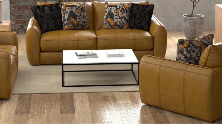 Modern living room with brown leather sofa, coffee table, and decorative pillows.