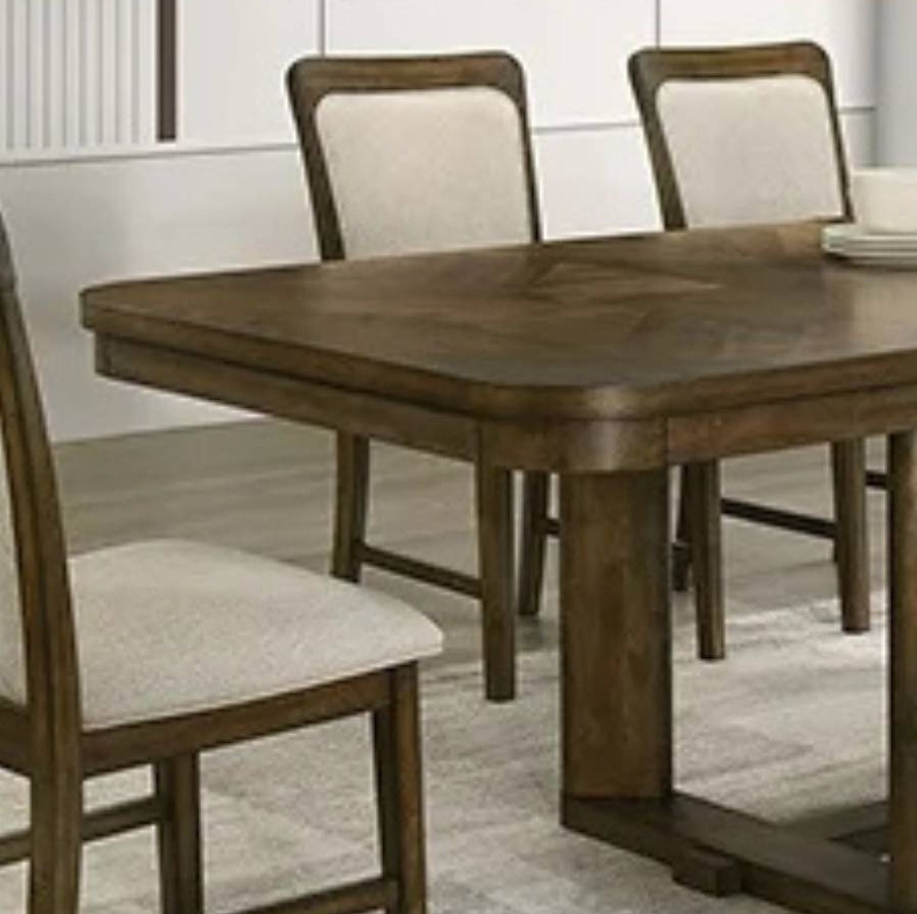 A wooden dining table with matching upholstered chairs in a bright dining room setting.