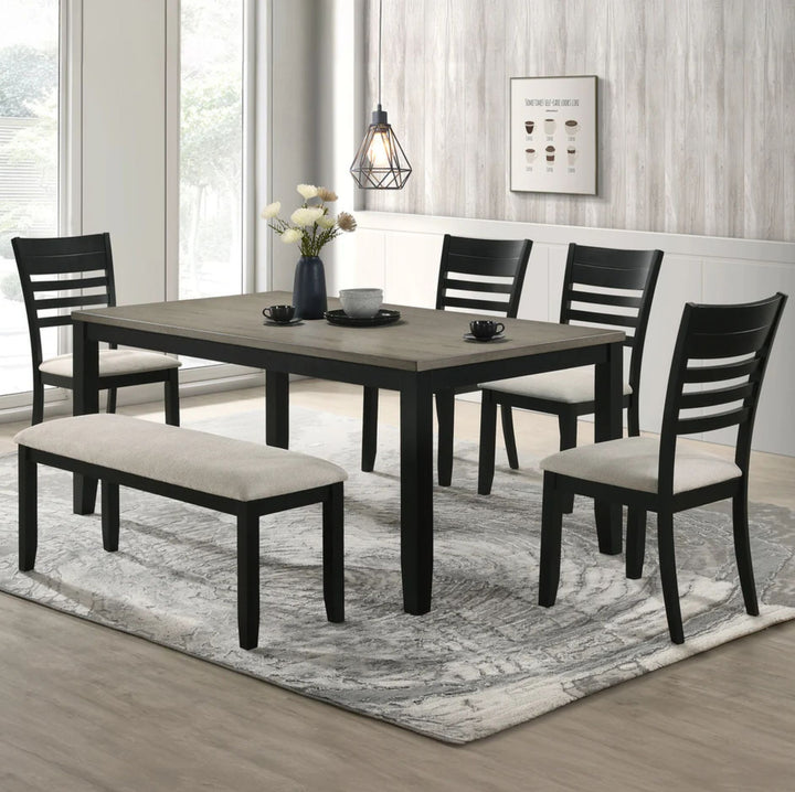 A 5-piece dining room set featuring a rectangular dark wood table, four black ladder-back chairs, and a matching bench with cream upholstered seats, arranged on a gray patterned area rug in a bright dining room.