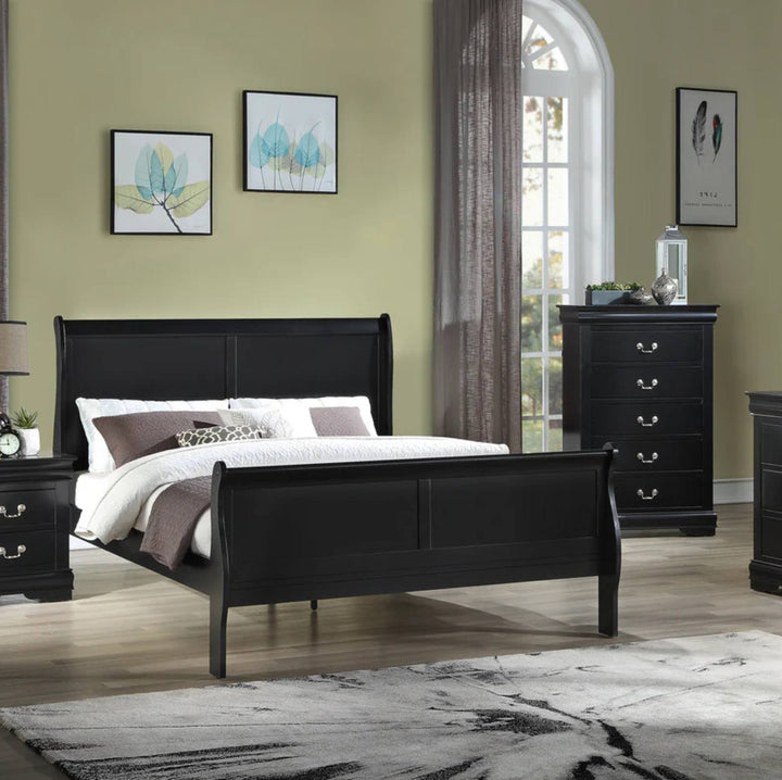 A black wooden sleigh bed frame is shown in a styled bedroom setting with a matching black dresser, nightstand, rug, and wall art against a sage green wall.