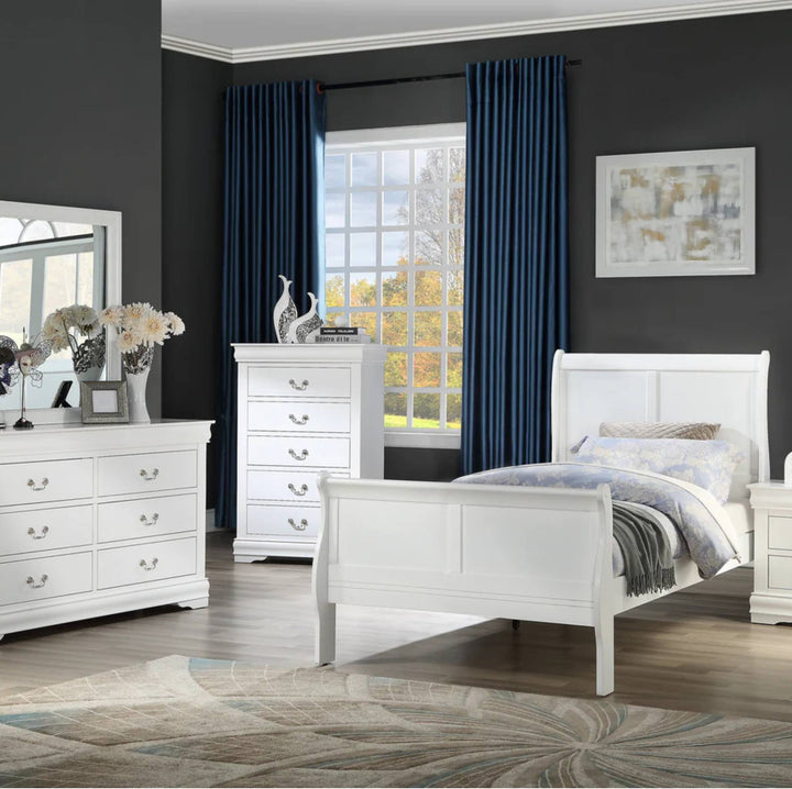 A staged bedroom featuring a white wooden bed frame, matching white dresser, and white chest of drawers, set against dark gray walls with deep blue curtains and a window view.