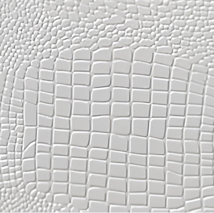 A close-up of a light gray textured surface with a raised embossed pattern, transitioning from small irregular bumps to a larger grid-like scale.