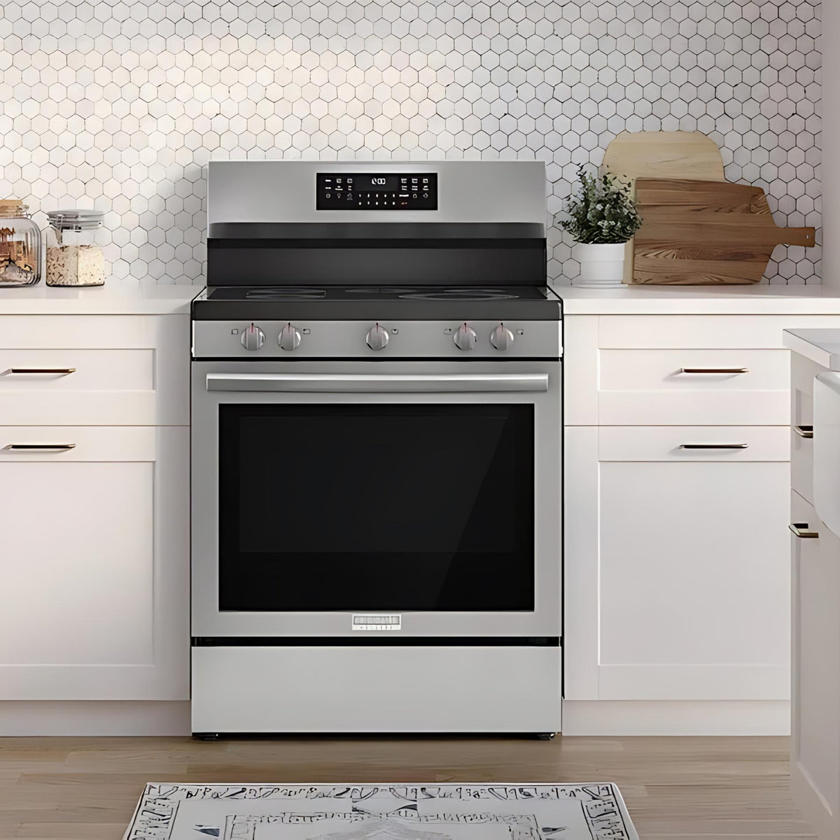 Stainless steel oven in a modern kitchen with white cabinets and hexagonal tile backsplash.