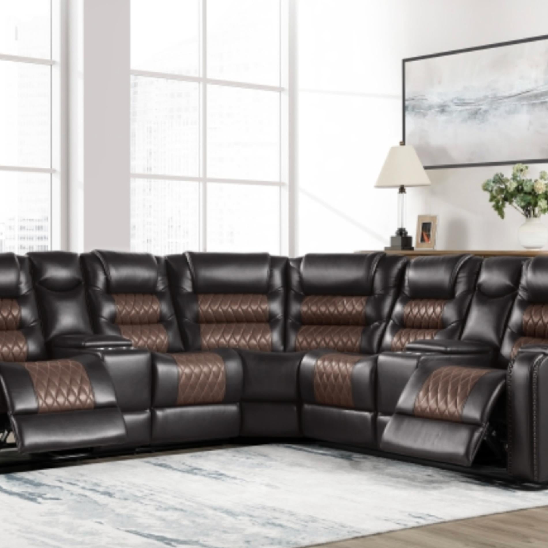 Black leather sectional sofa with brown accents in a living room setting.