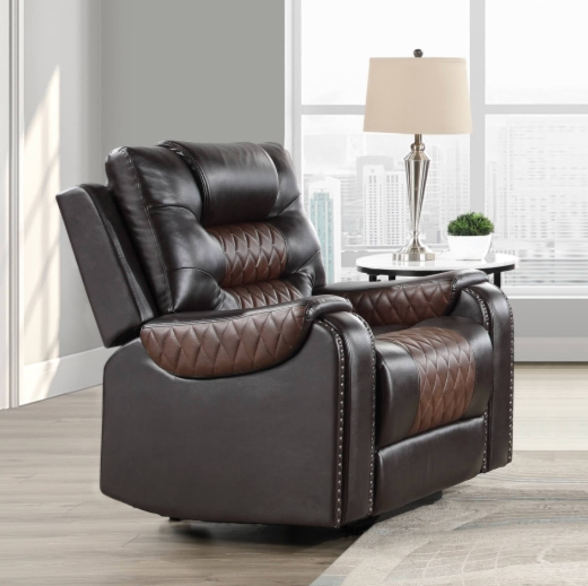 A dark brown recliner chair with quilted brown leather panels, shown in a modern living room setting with a window, city view, and a side table with a lamp.