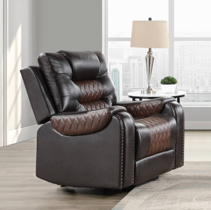 A dark brown recliner chair with quilted brown leather panels, shown in a modern living room setting with a window, city view, and a side table with a lamp.
