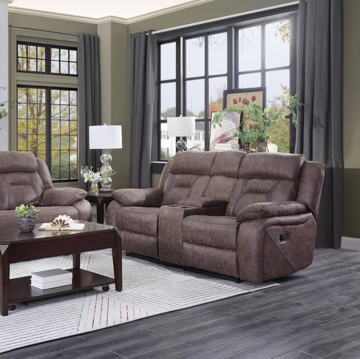 A brown upholstered reclining loveseat sofa shown in a staged living room with matching armchair, coffee table, lamps, windows, curtains, and wood flooring.