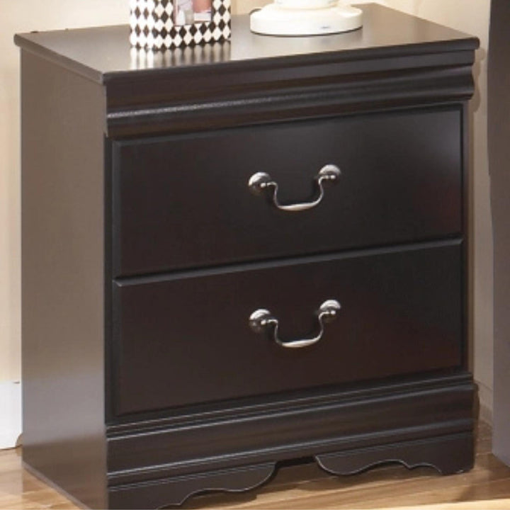 Dark wood nightstand with two drawers and metal handles on a neutral background