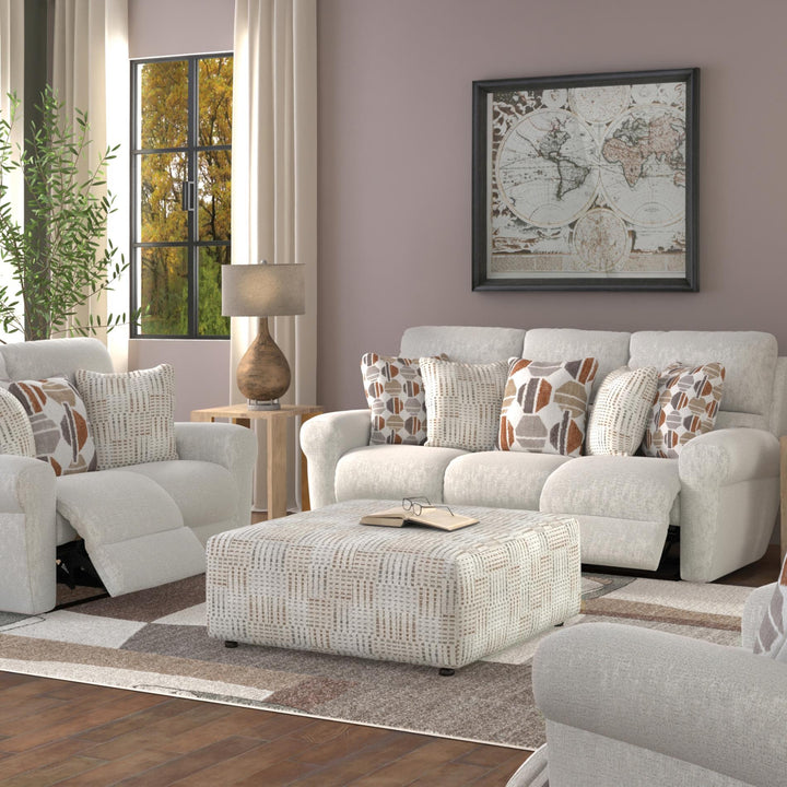 Living room with a gray sofa, ottoman, and decorative pillows.