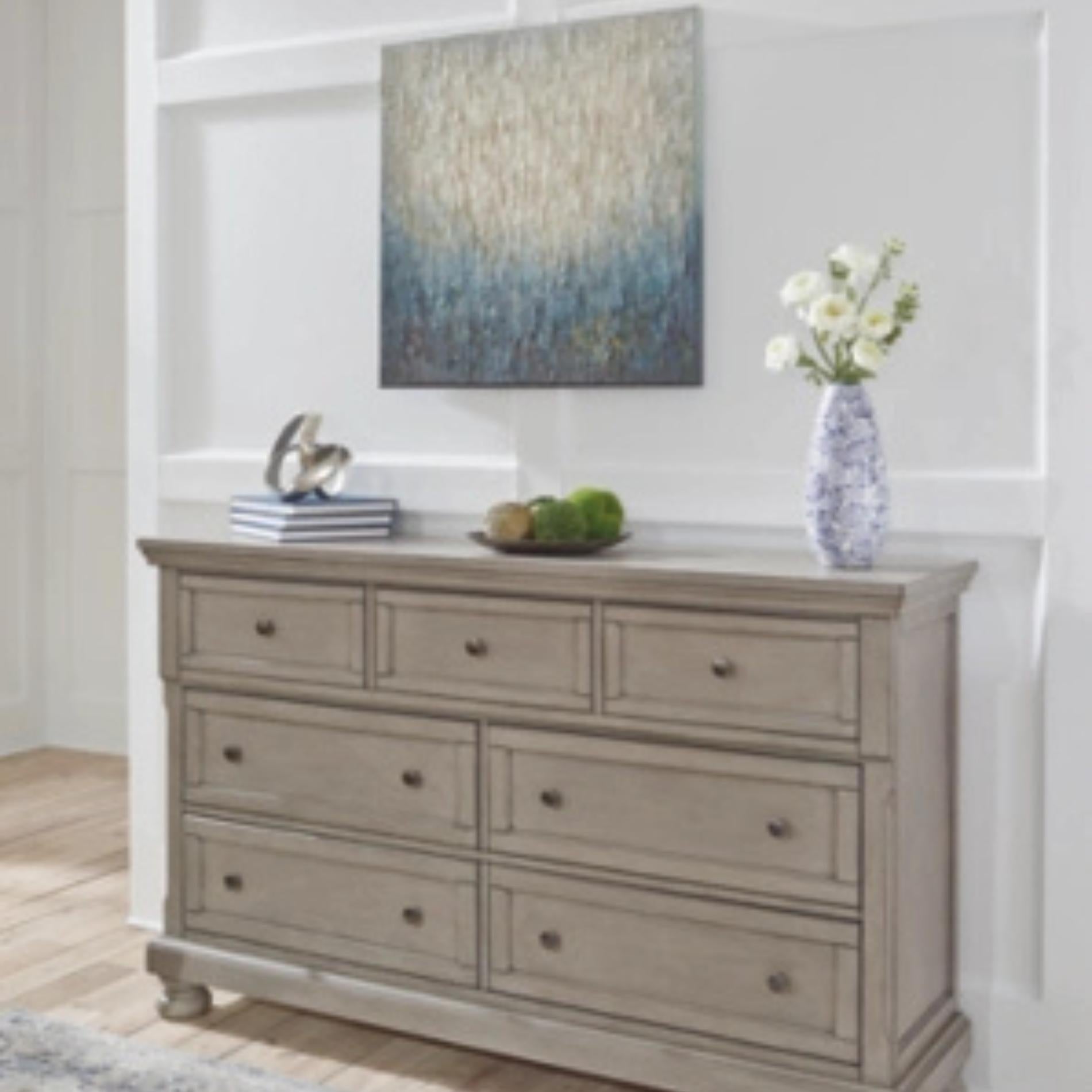 Wooden dresser with decorative items in a room setting