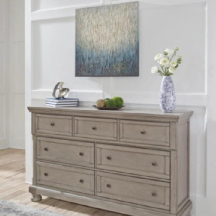 Wooden dresser with decorative items in a room setting