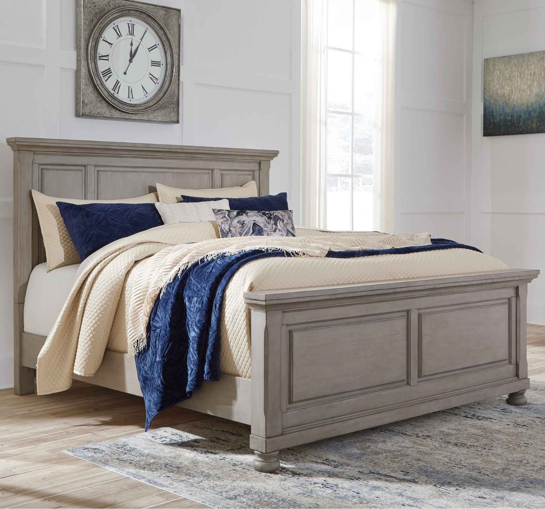 Bedroom with a wooden bed, beige bedding, and decorative pillows.