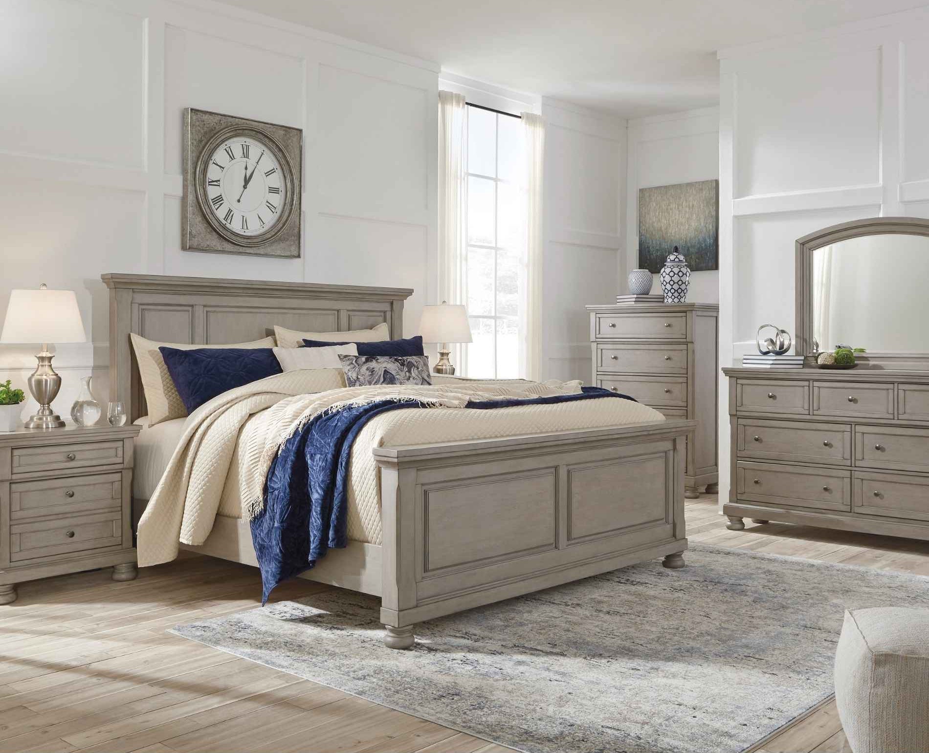 Neatly arranged bedroom with wooden furniture including a bed, nightstands, and dressers.
