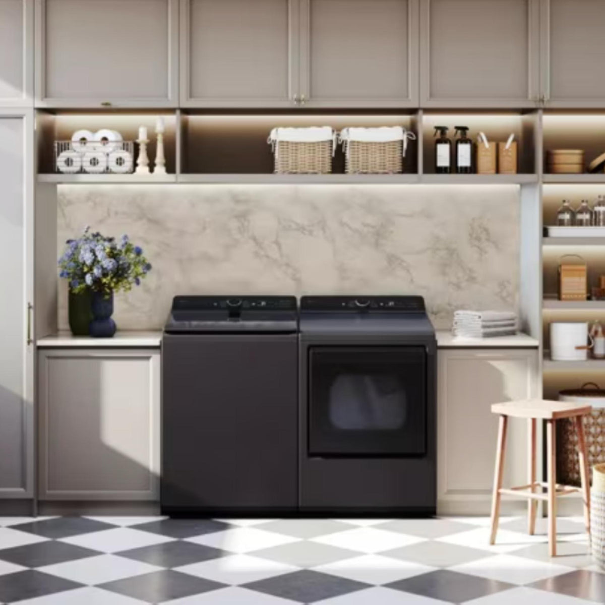 Black washer and dryer set against a neutral-toned kitchen wall with decorative elements.