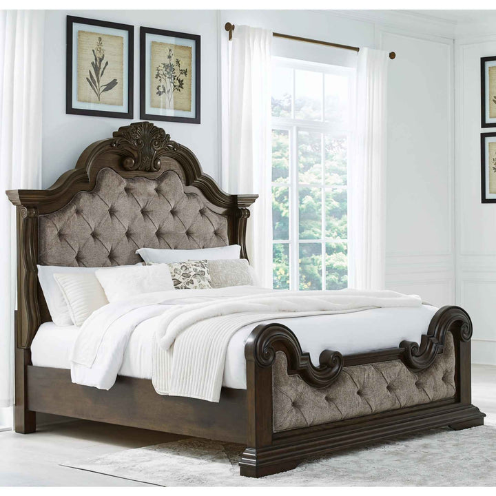 Wooden bed with tufted headboard in a bedroom setting