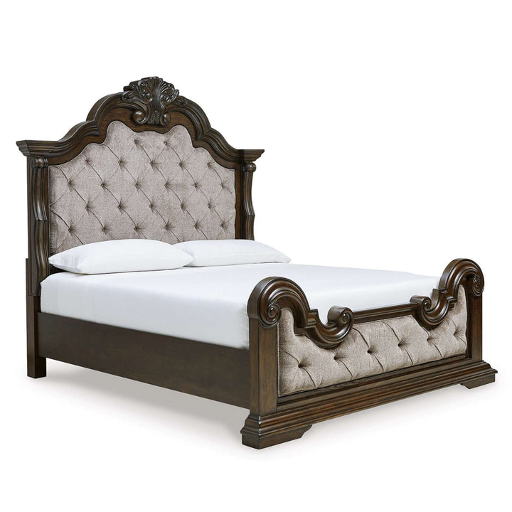 Decorative bed with tufted headboard and footboard on a white background